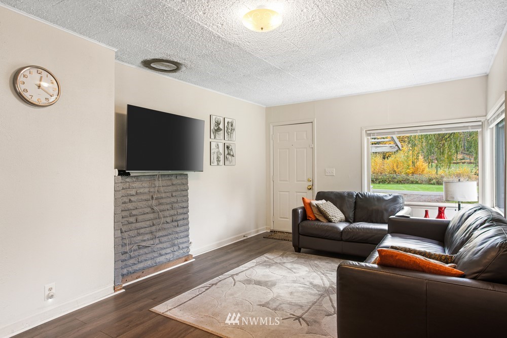 7838 South Langston Road Seattle, WA 98178 - Photo 17 of 27 a living room with furniture and a flat screen tv