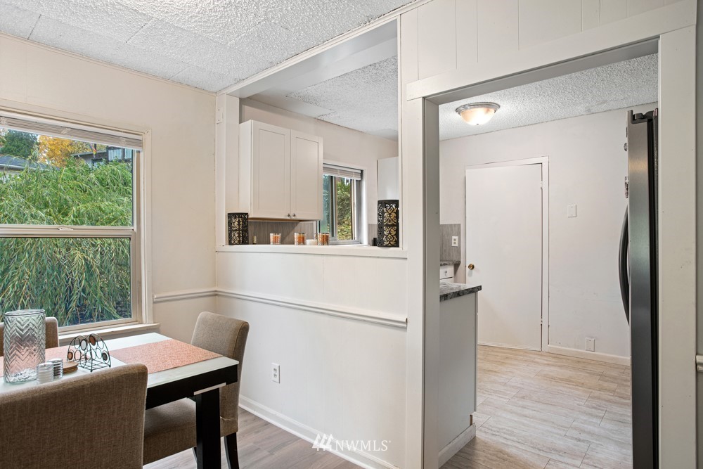 7838 South Langston Road Seattle, WA 98178 - Photo 21 of 27 a view of a dining room with furniture window and wooden floor