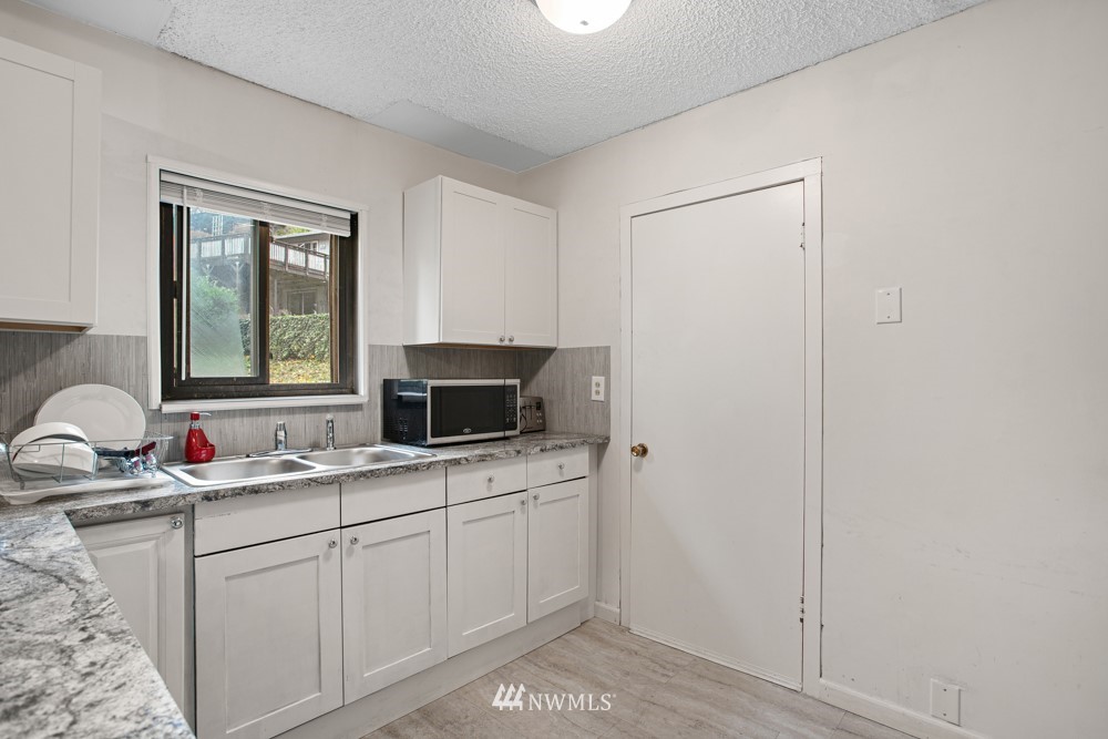 7838 South Langston Road Seattle, WA 98178 - Photo 23 of 27 a bathroom with a sink and a mirror