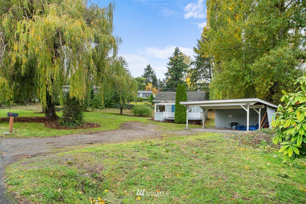 7838 South Langston Road Seattle, WA 98178 - Photo 9 of 27 a view of a house with backyard and trees