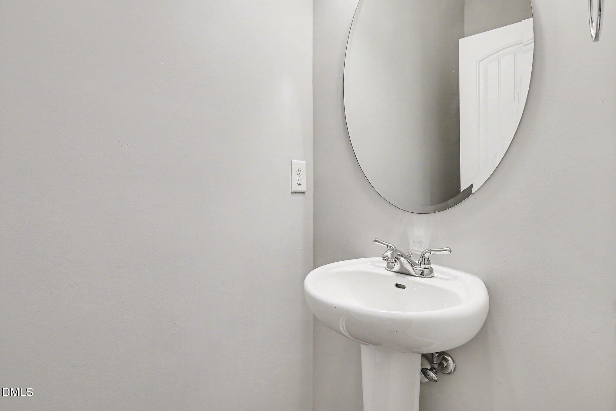 4818 Landover Bluff Way Raleigh, NC 27616 - Photo 15 of 30 a bathroom with a sink and a mirror
