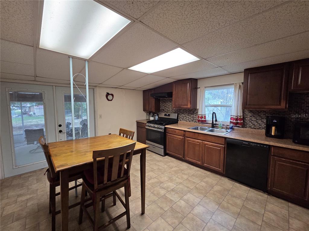 124 East F Street Frostproof, FL 33843 - Photo 11 of 37 a kitchen with a dining table chairs and sink