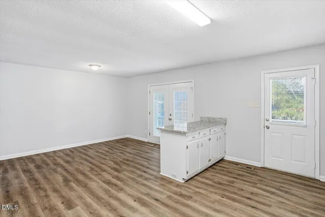 a kitchen with granite countertop a refrigerator stove and sink