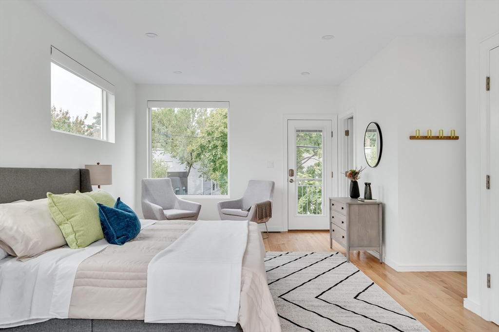 86 School Street Cambridge, MA 02139 - Photo 13 of 35 a bedroom with furniture large window and wooden floor
