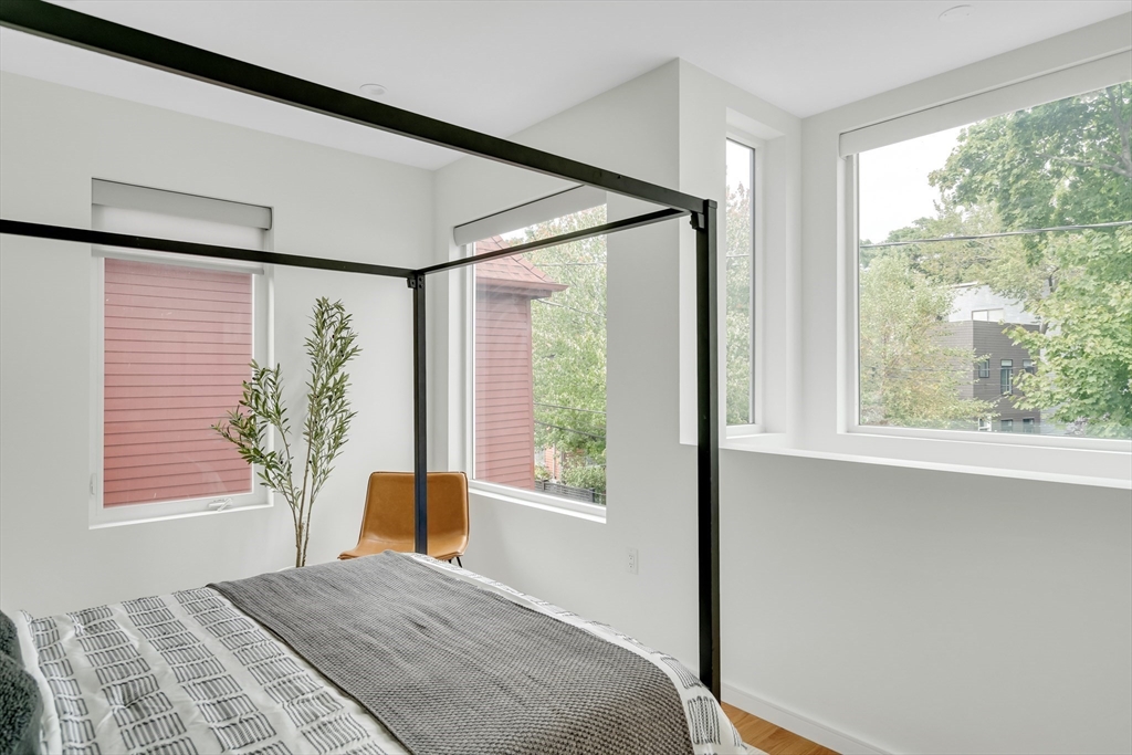 86 School Street Cambridge, MA 02139 - Photo 21 of 35 a bedroom with a bed and a large window with outer view