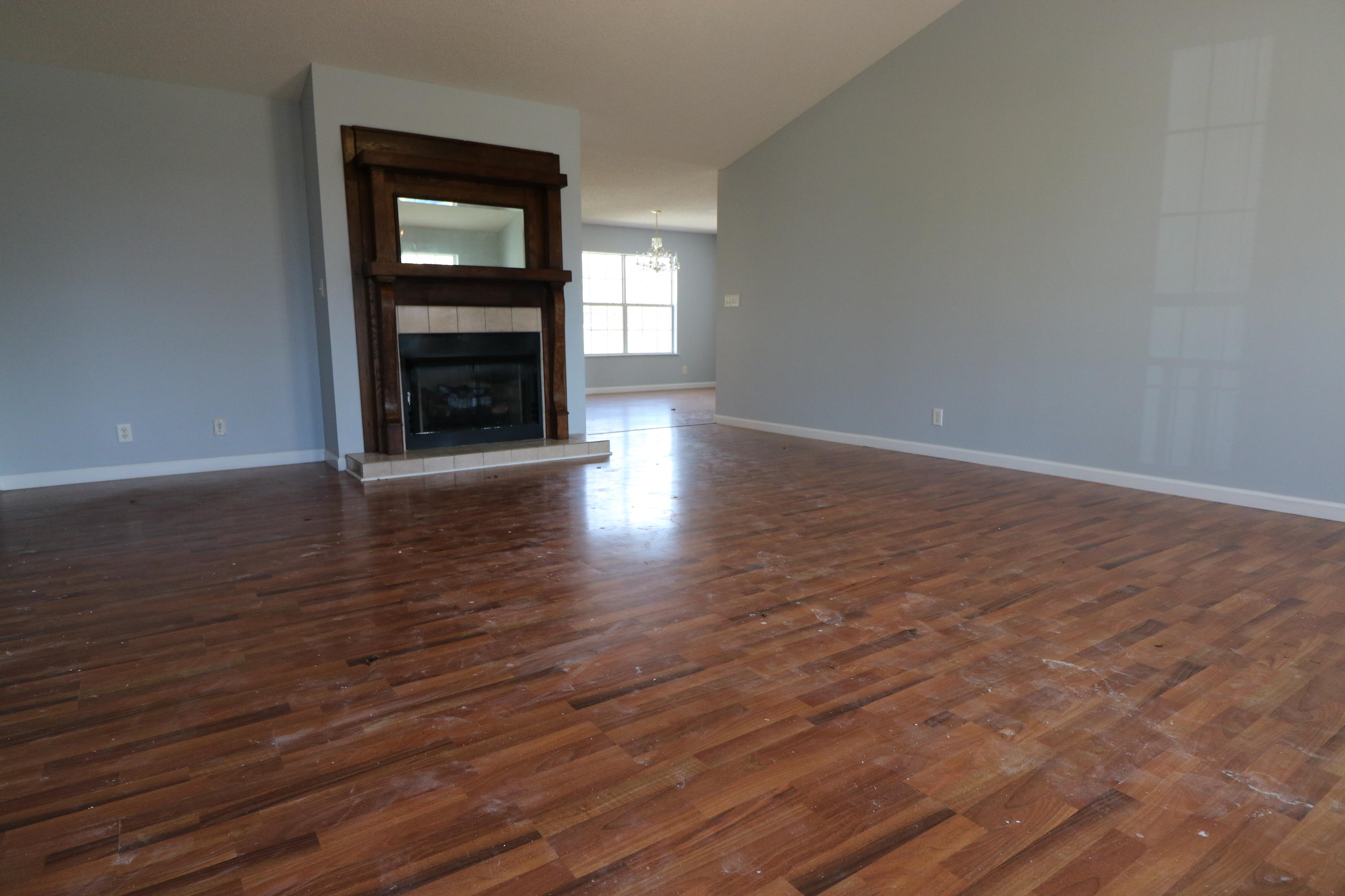 1333 Deer Path Road Chipley, FL 32428 - Photo 6 of 24 a view of an empty room with wooden floor fireplace and a window