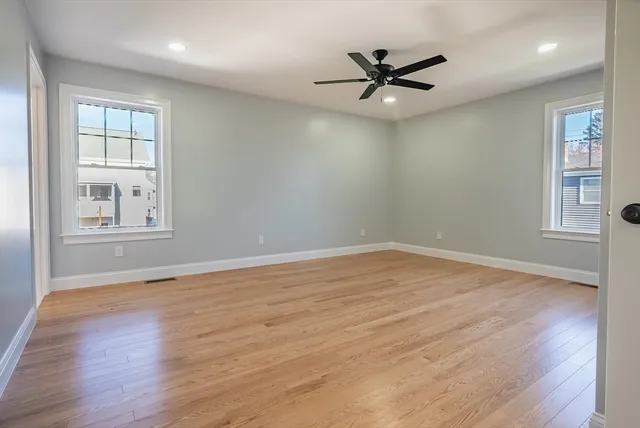 wooden floor in an empty room with a window