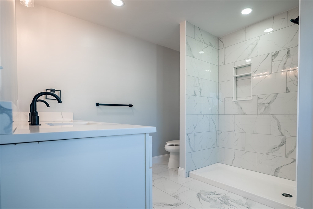 126 Wheeler Street Fall River, MA 02724 - Photo 13 of 29 a bathroom with a sink a toilet and shower