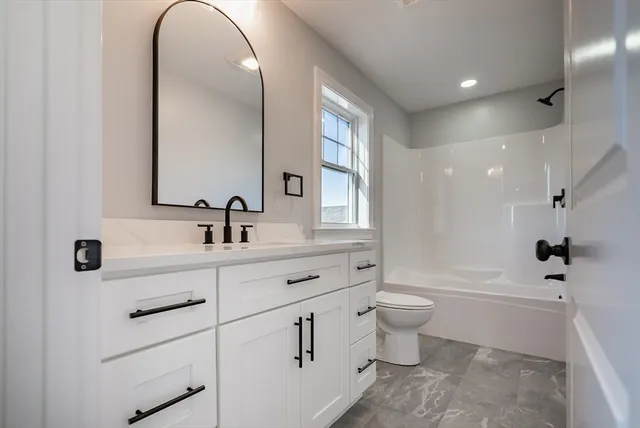 a bathroom with a double vanity sink toilet and a mirror