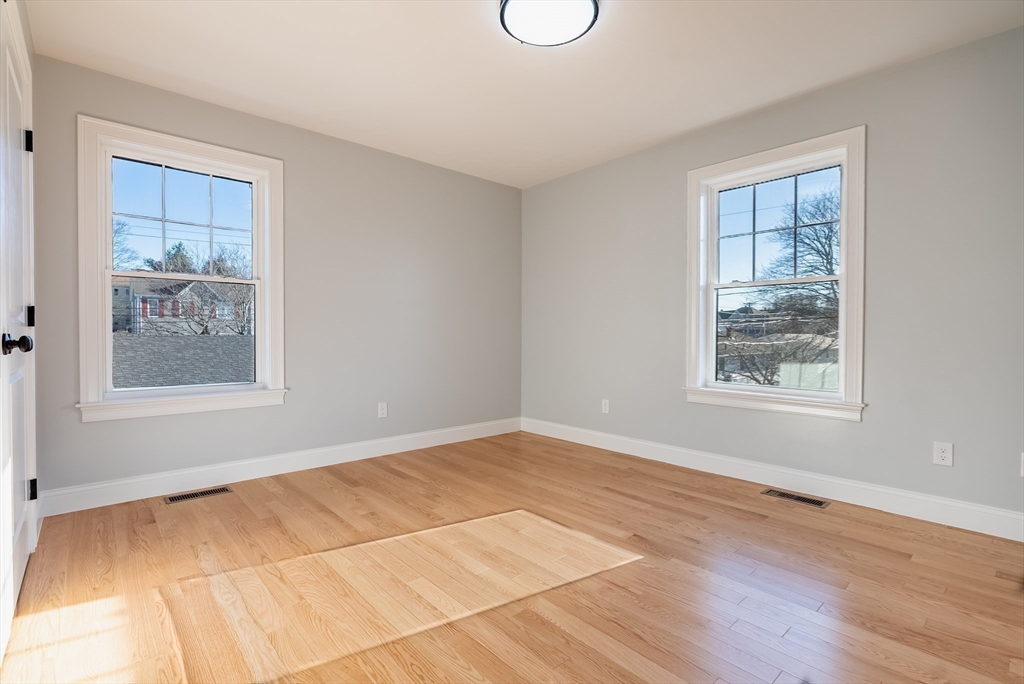 126 Wheeler Street Fall River, MA 02724 - Photo 17 of 32 a view of an empty room with wooden floor and a window