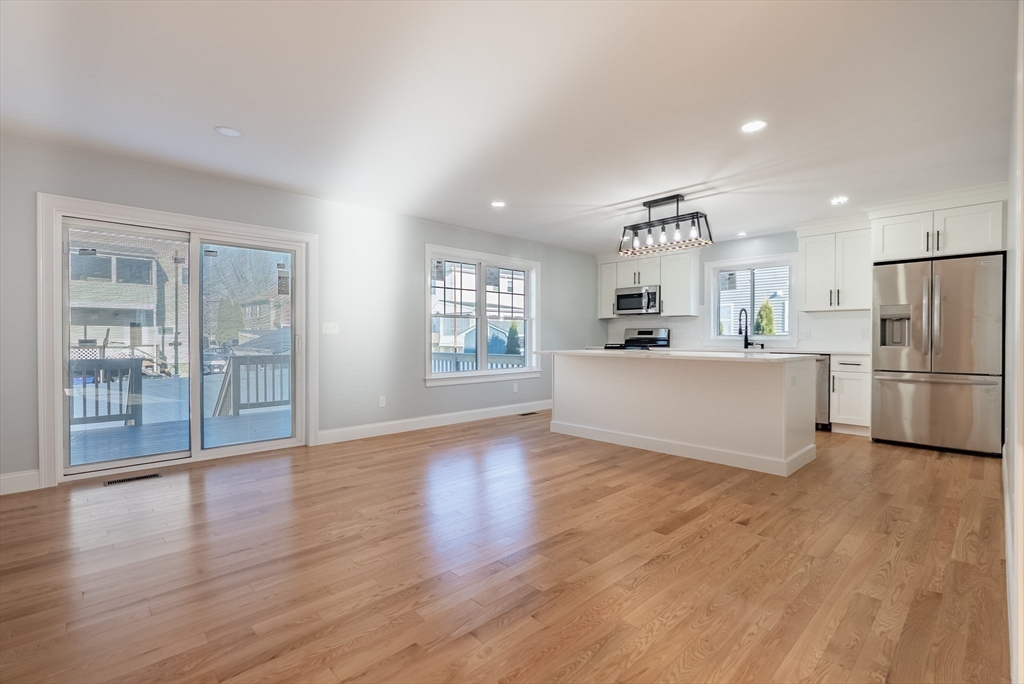 126 Wheeler Street Fall River, MA 02724 - Photo 6 of 29 a kitchen with stainless steel appliances a refrigerator and wooden floor
