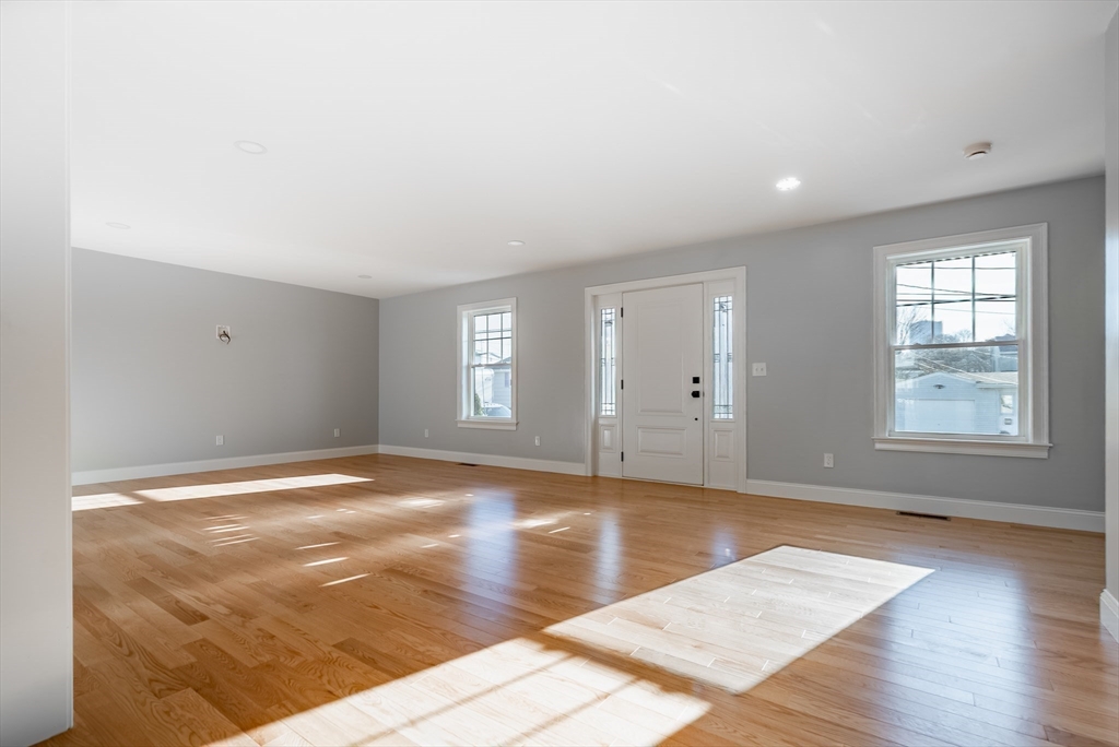 126 Wheeler Street Fall River, MA 02724 - Photo 7 of 32 a view of an empty room with window and wooden floor