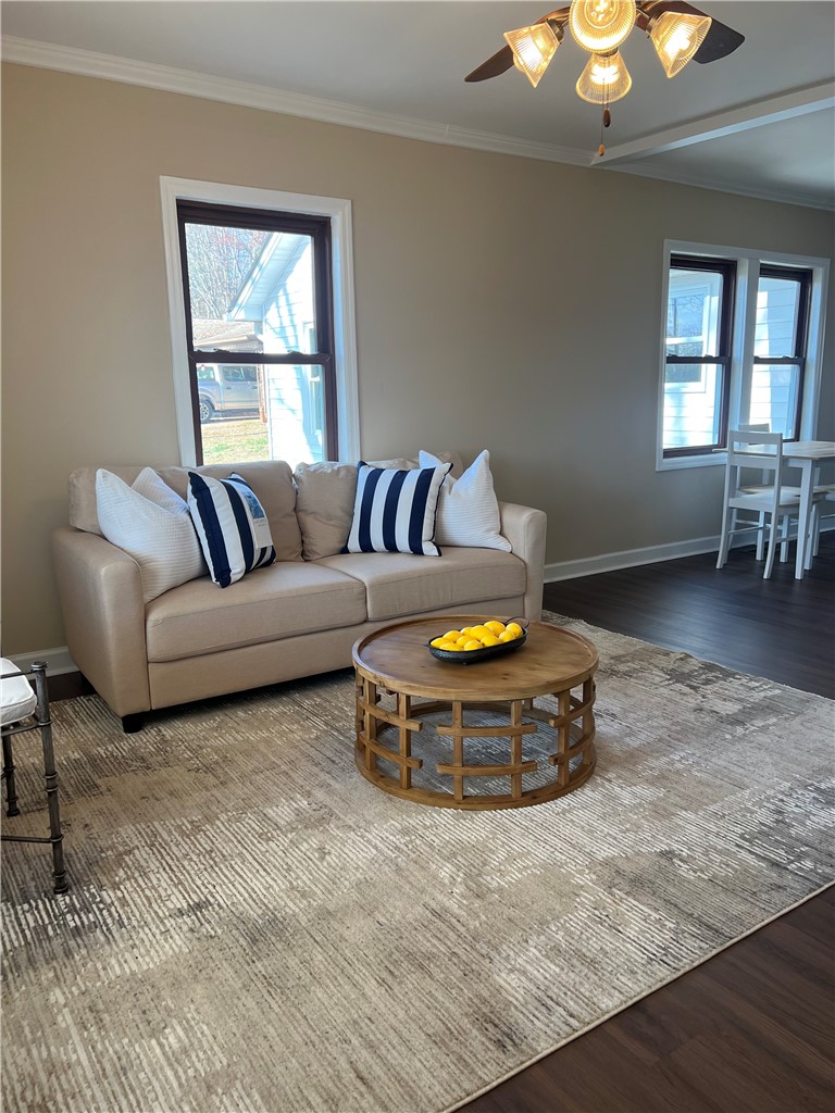204 Old Salem Road Seneca, SC 29672 - Photo 6 of 28 This inviting space features elegant crown molding and rich hardwood flooring, perfect for comfortable living.