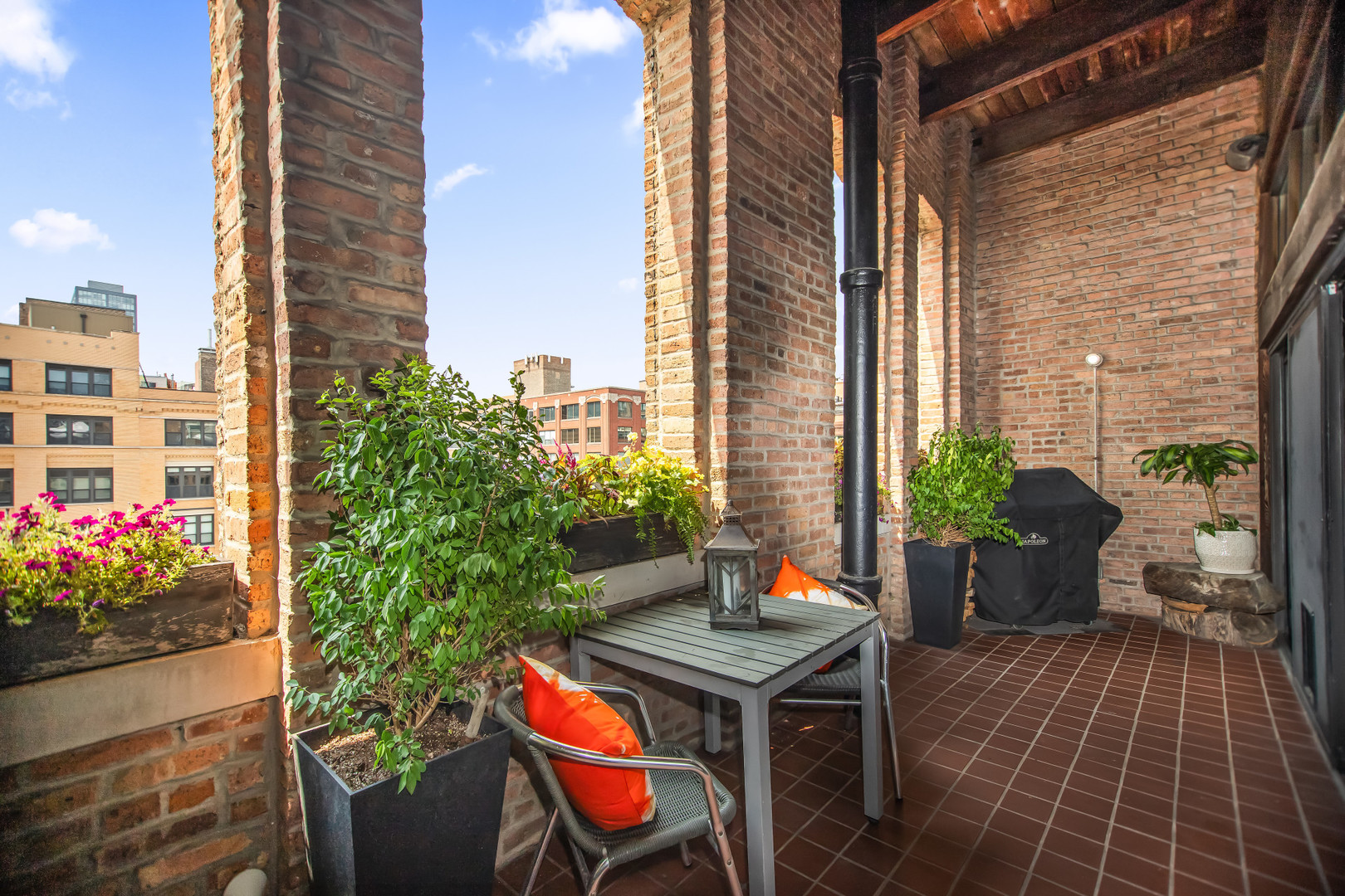 400 South Green Street, Unit 508 Chicago, IL 60607 - Photo 16 of 24 a view of a patio with table and chairs potted plants with wooden floor