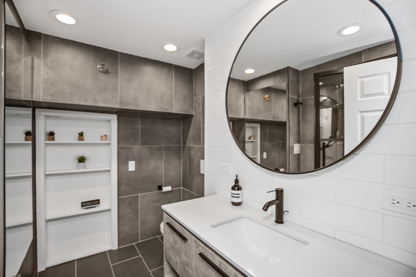 400 South Green Street, Unit 508 Chicago, IL 60607 - Photo 17 of 24 a bathroom with a sink a mirror and a shower