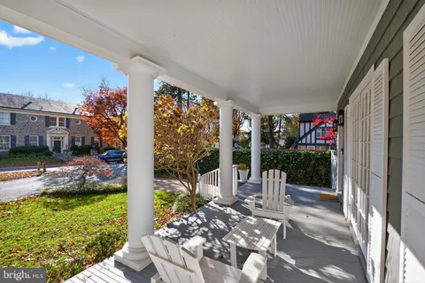 a view of a porch with chairs and potted plants