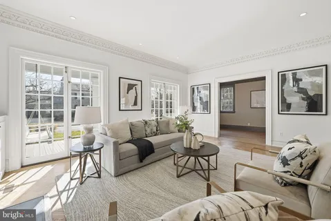 a living room with furniture a fireplace and a table