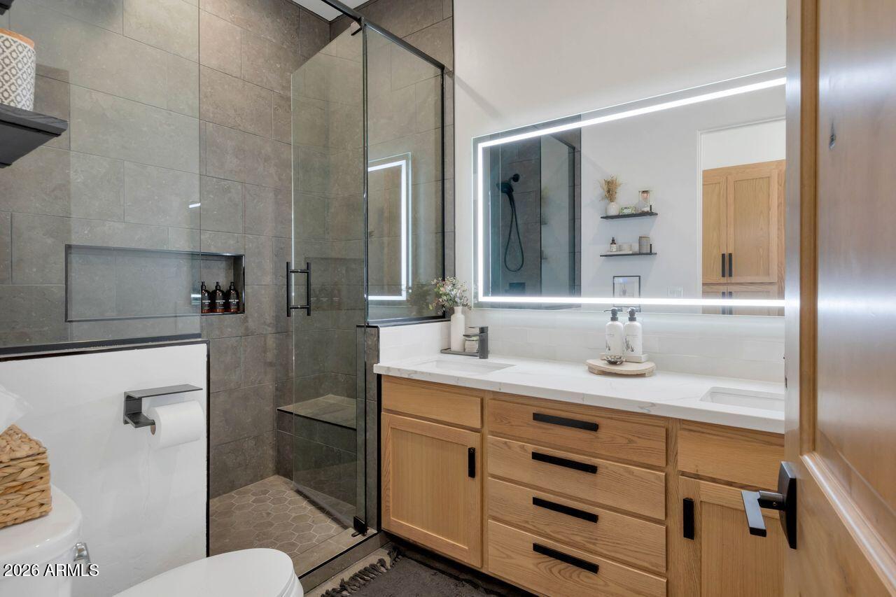 1605 North Page Springs Road Cornville, AZ 86325 - Photo 25 of 51 a bathroom with a granite countertop sink mirror vanity and toilet