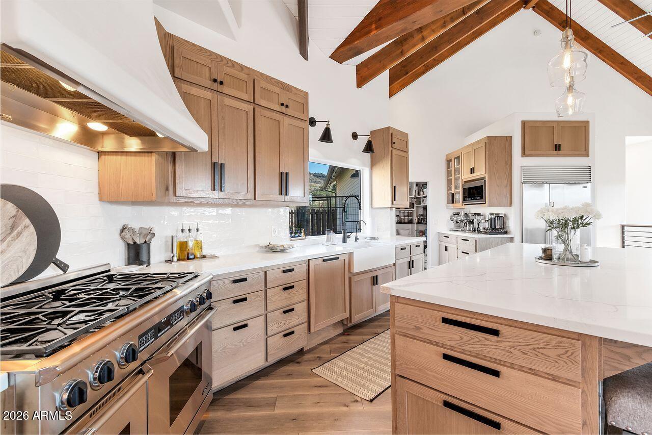 1605 North Page Springs Road Cornville, AZ 86325 - Photo 9 of 51 a kitchen with kitchen island granite countertop a sink cabinets and stainless steel appliances