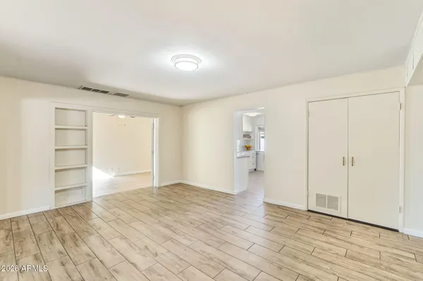 a view of empty room with wooden floor
