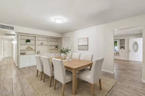 a view of a dining room with furniture and wooden floor