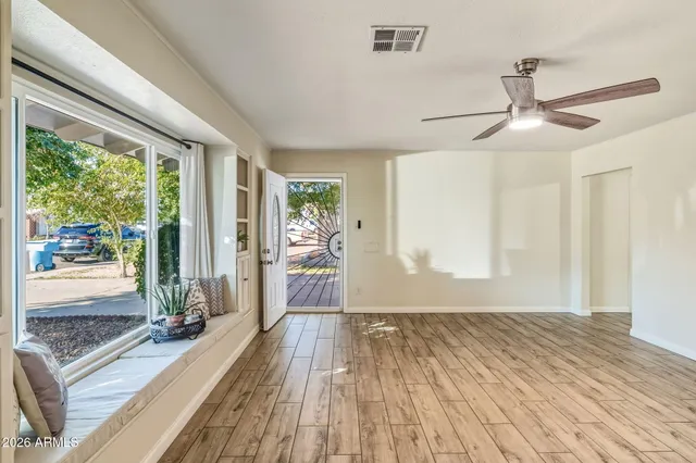 a kitchen with granite countertop white cabinets and stainless steel appliances