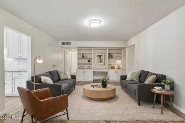 a living room with furniture and a potted plant