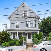 a view of a white car parked in front of house