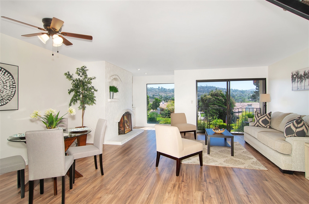 1939 Alga Road, Unit D Carlsbad, CA 92009 - Photo 1 of 25 Spacious living room offers new flooring, paint, fireplace, great views and sliding doors to a patio.
