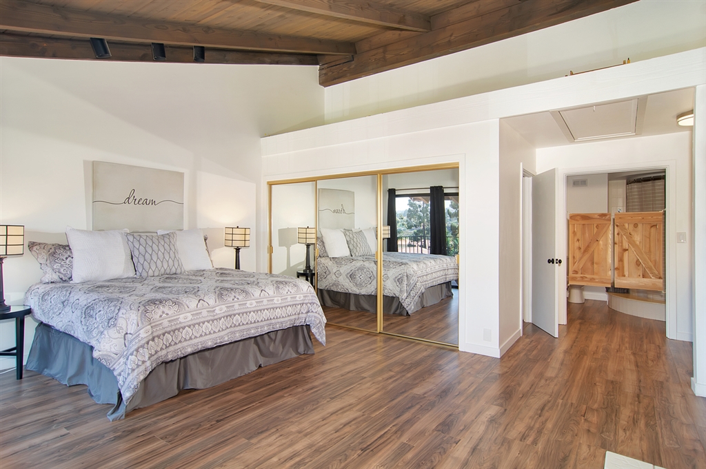1939 Alga Road, Unit D Carlsbad, CA 92009 - Photo 11 of 25 Master bedroom with mirrored wardrobe doors.