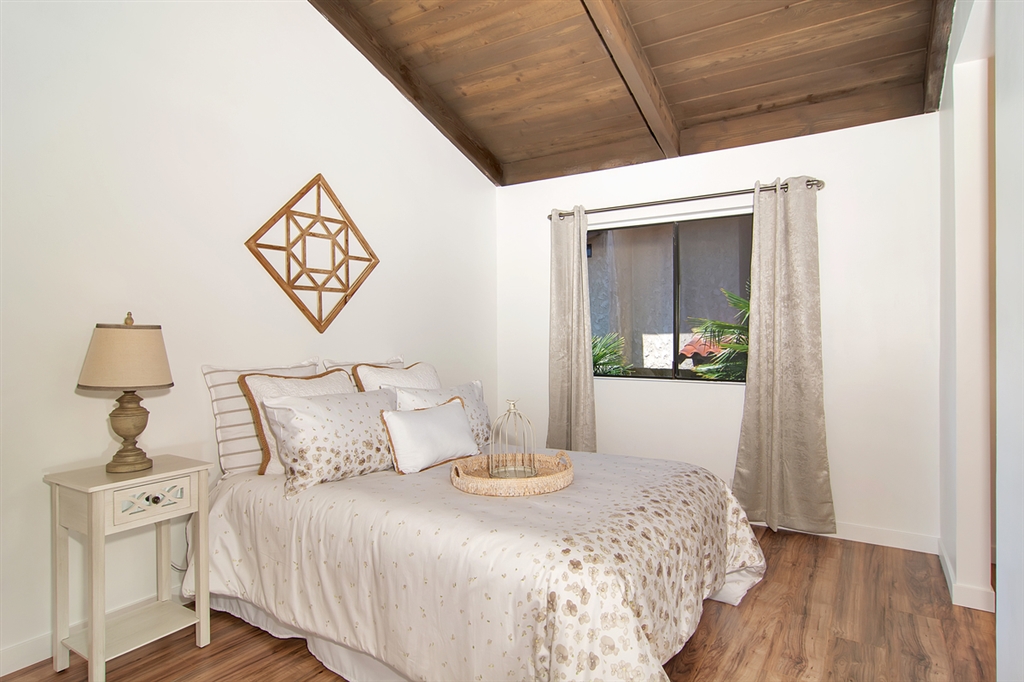 1939 Alga Road, Unit D Carlsbad, CA 92009 - Photo 15 of 25 The guest bedroom has new flooring, vaulted wood ceilings and its own bathroom.