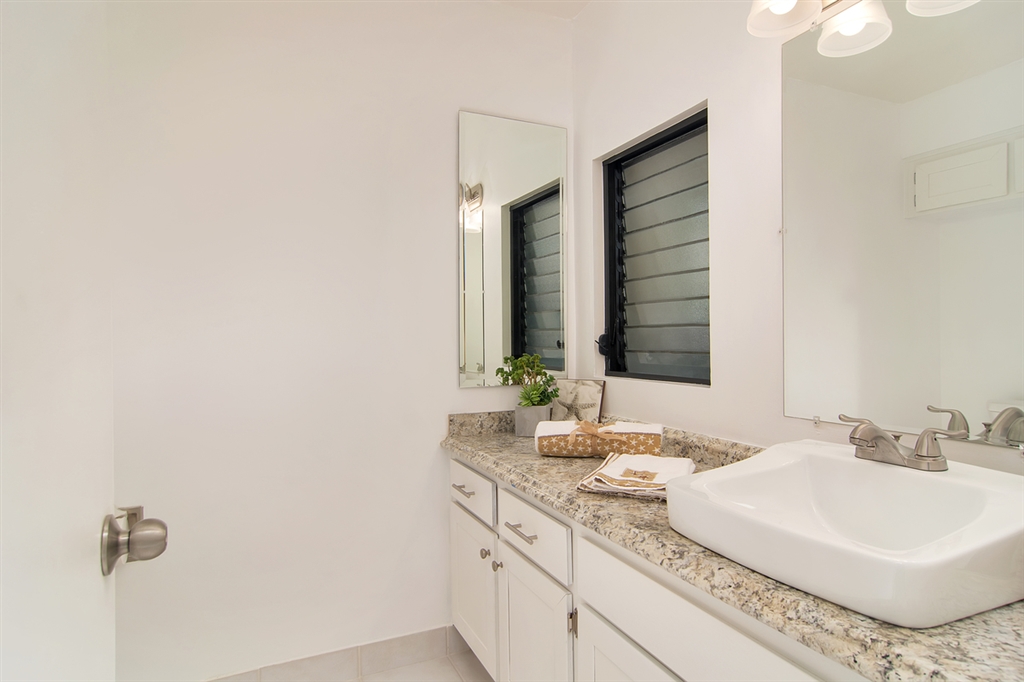 1939 Alga Road, Unit D Carlsbad, CA 92009 - Photo 8 of 25 The downstairs bathroom offers new cabinets and granite countertop.