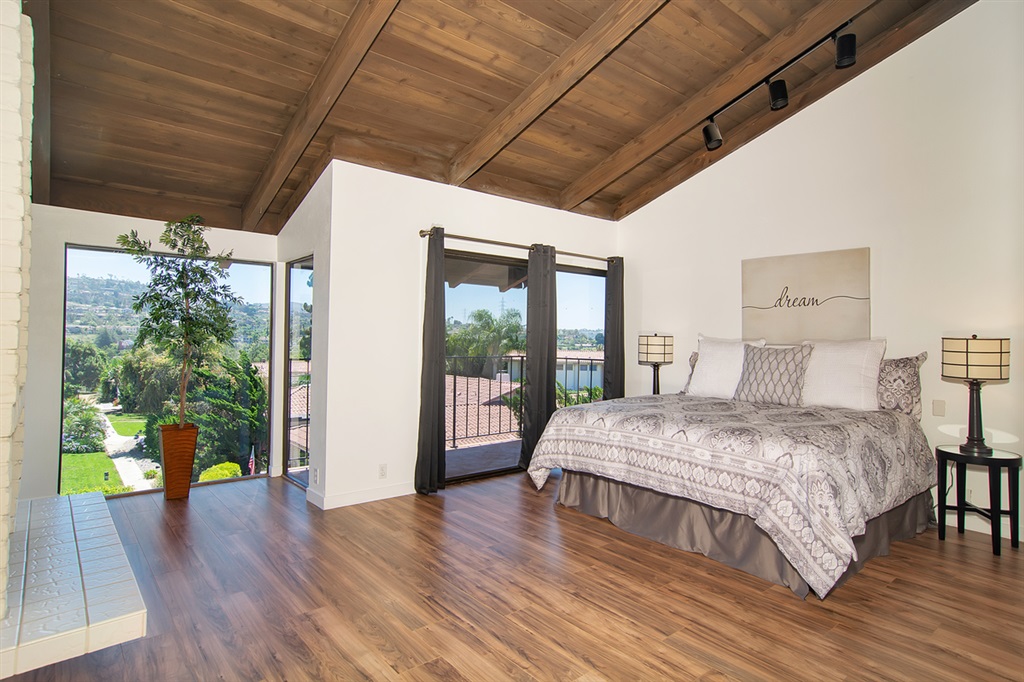 1939 Alga Road, Unit D Carlsbad, CA 92009 - Photo 9 of 25 The spacious master bedroom offers vaulted wood ceilings, new wood flooring, a fireplace and sliding doors to the view deck.