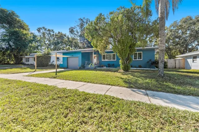 a view of a house with swimming pool and a yard