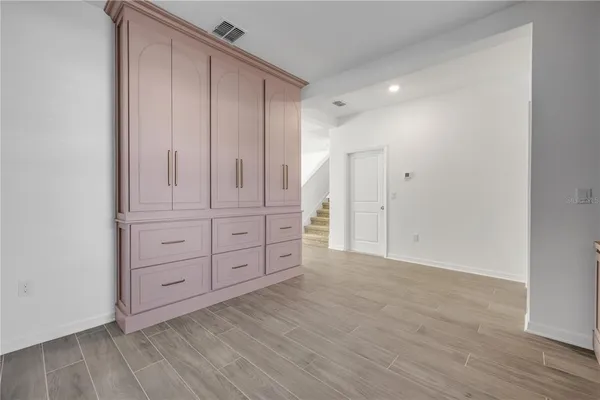 a kitchen that has a sink a stove and cabinets