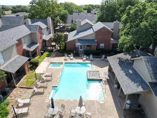 an aerial view of a house with swimming pool and patio