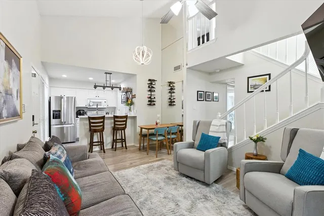 a living room with furniture and kitchen view