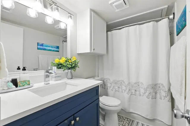 a bathroom with a sink toilet and shower