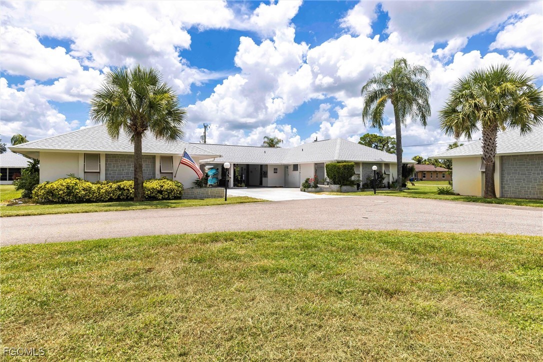 365 Westpark Road Lehigh Acres, FL 33936 - Photo 2 of 15 a view of multiple houses with a yard