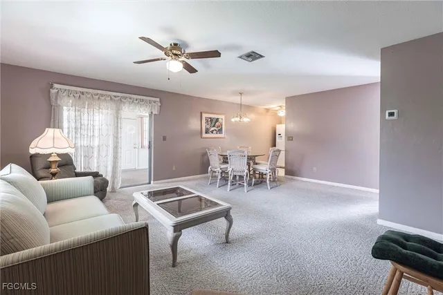 a living room with furniture and white walls