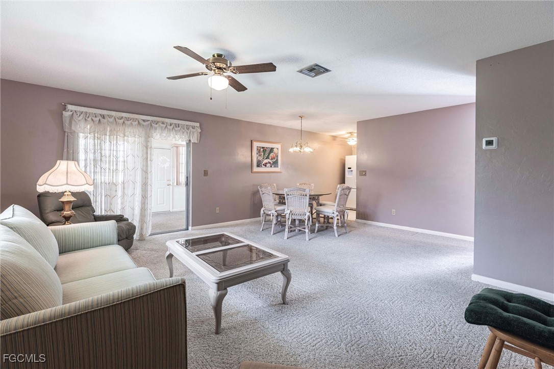 365 Westpark Road Lehigh Acres, FL 33936 - Photo 4 of 15 a living room with furniture and white walls