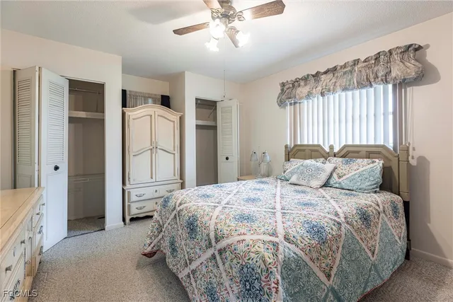 a spacious bedroom with a bed and a chandelier
