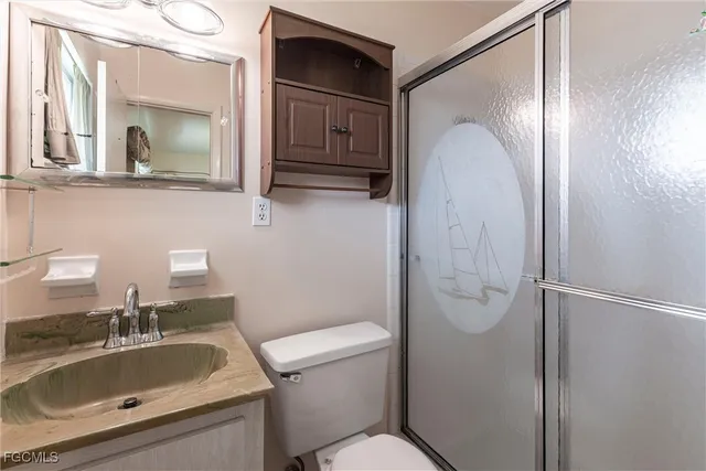 a bathroom with a sink toilet and mirror