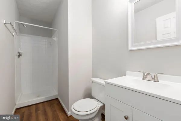 a bathroom with a sink a toilet and vanity