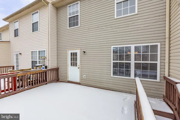 a view of a house with wooden deck