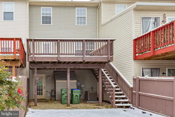 a front view of a house with deck and outdoor seating