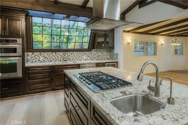 a kitchen with a stove a sink and a microwave