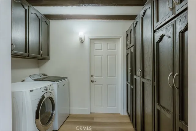 a view of a hallway with washer and dryer