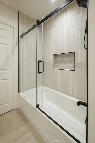 a bathroom with a bathtub and a shower