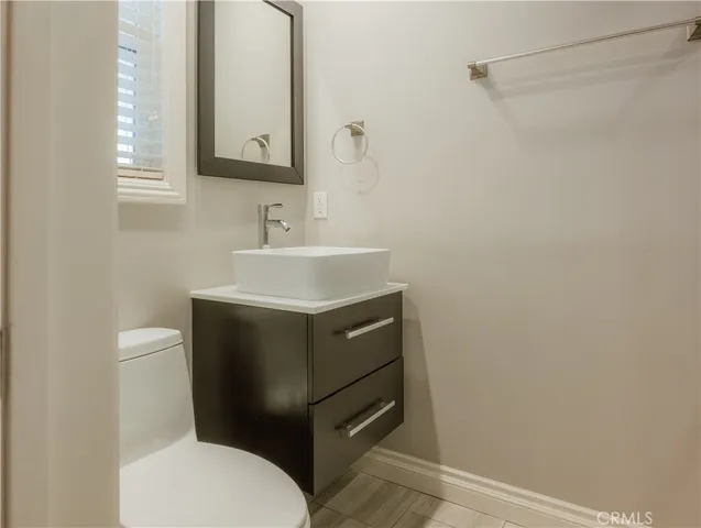 a bathroom with a sink vanity mirror and toilet